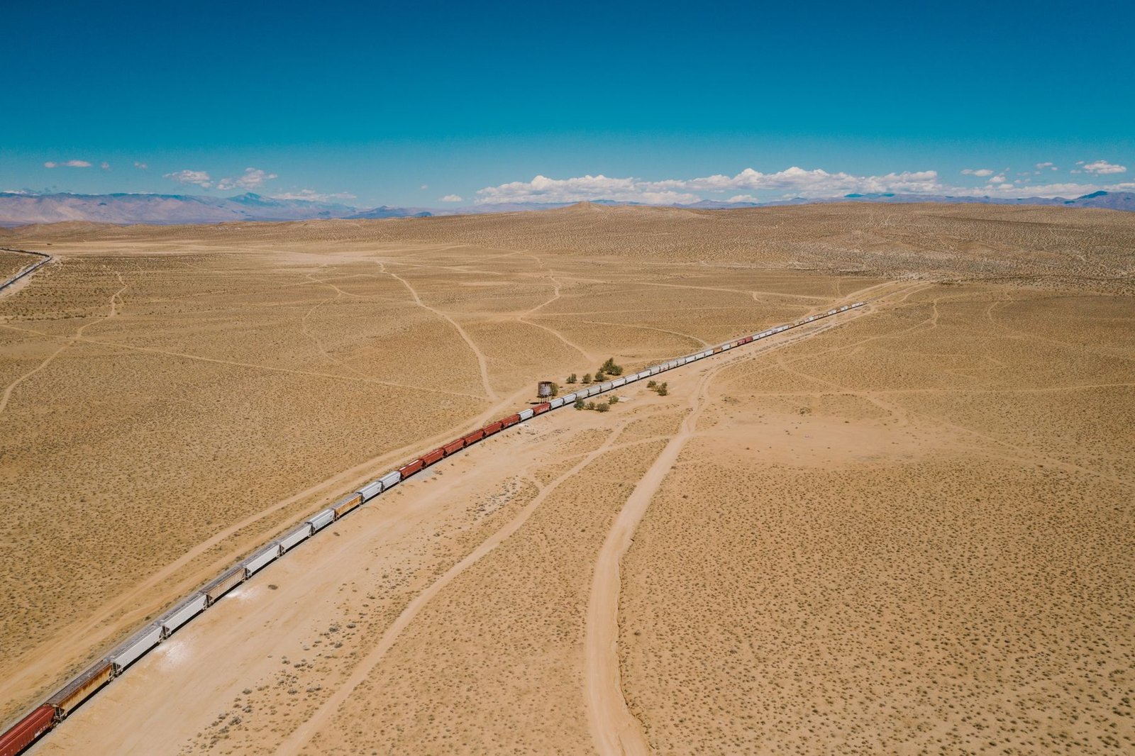 Freight train crossing a remote desert landscape